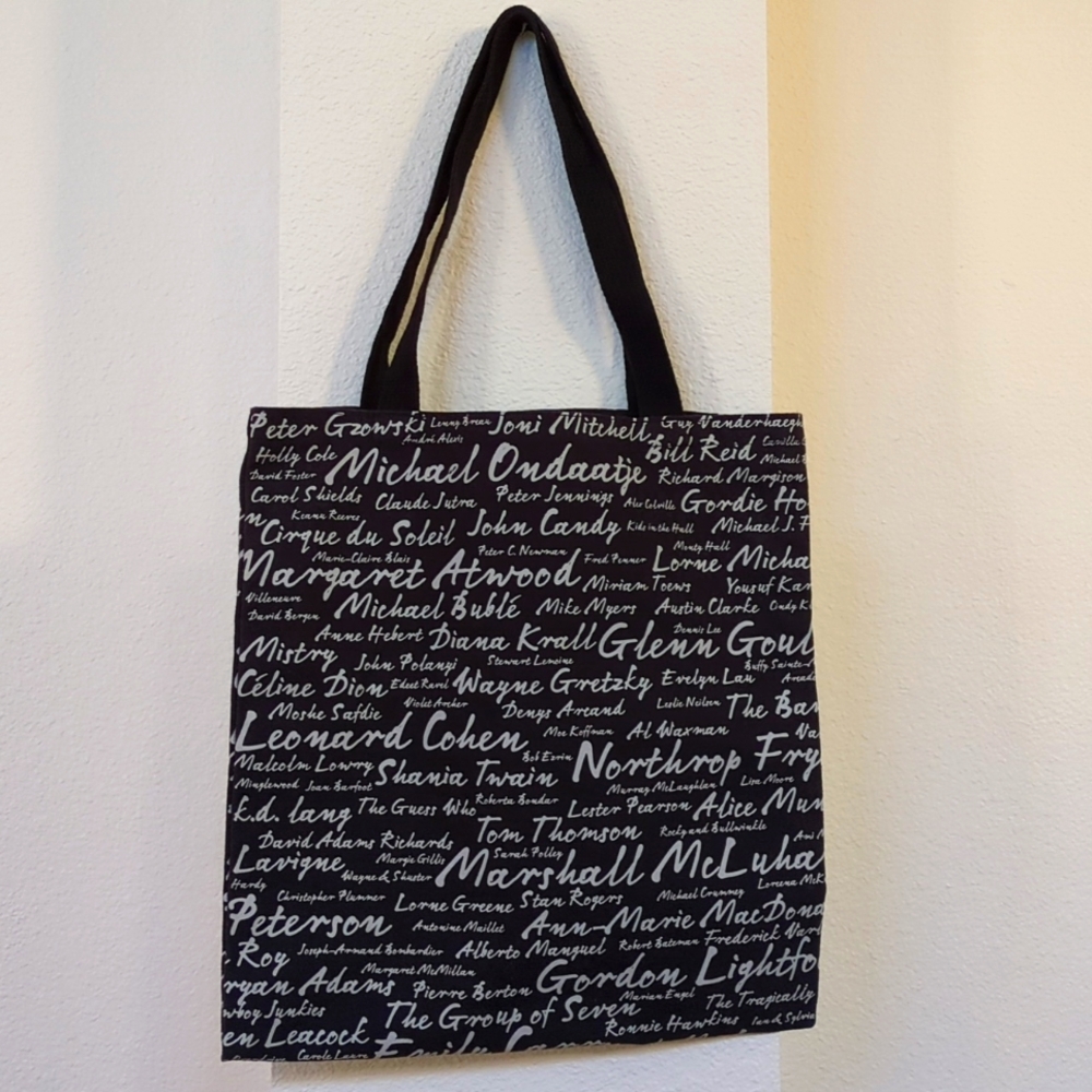 Black canvas tote bag printed with Canadian celebrities